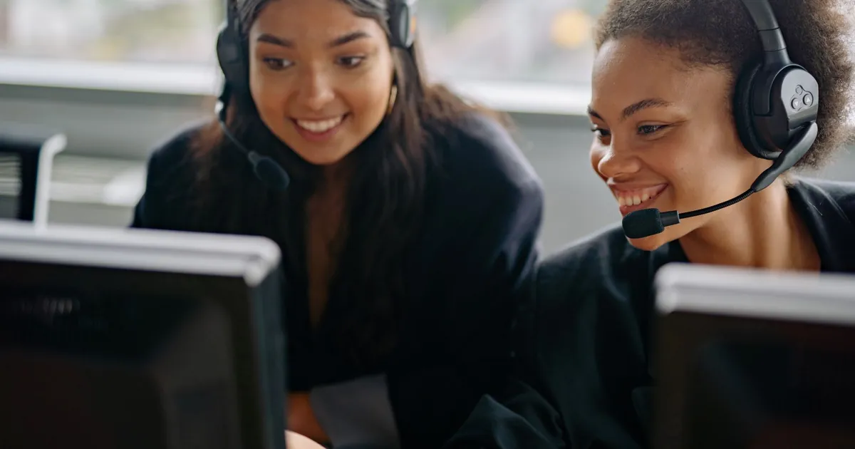Two cheerful call center agents at work, engaging with customers and providing support.