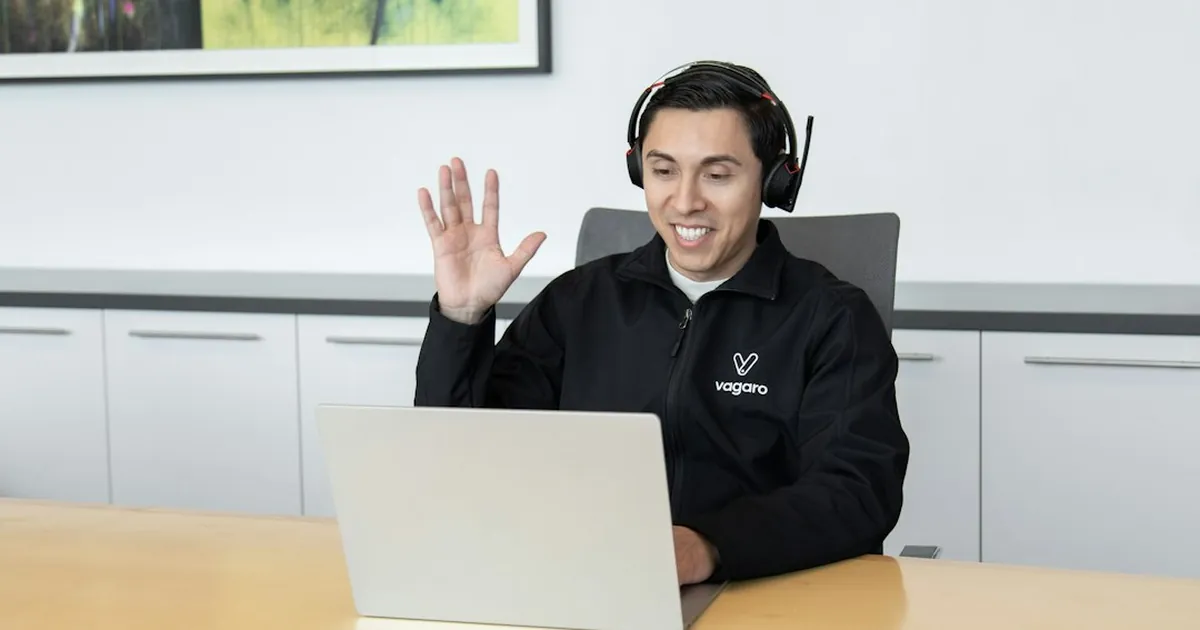 a man wearing headphones sitting in front of a laptop computer