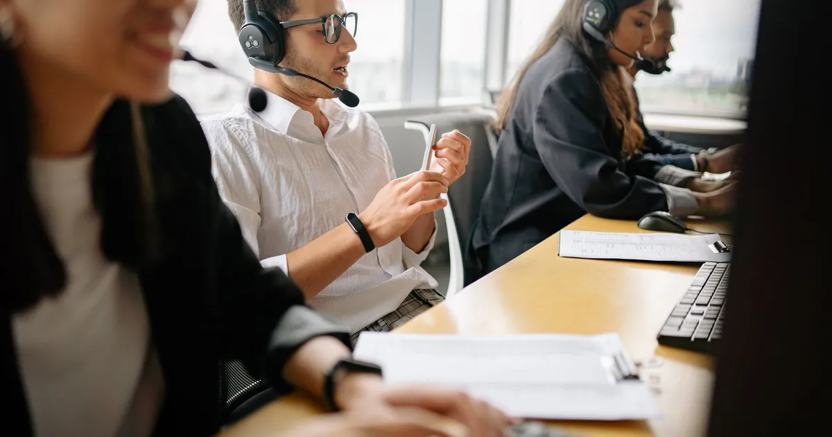 A diverse team of call center agents working together in a modern office setting.